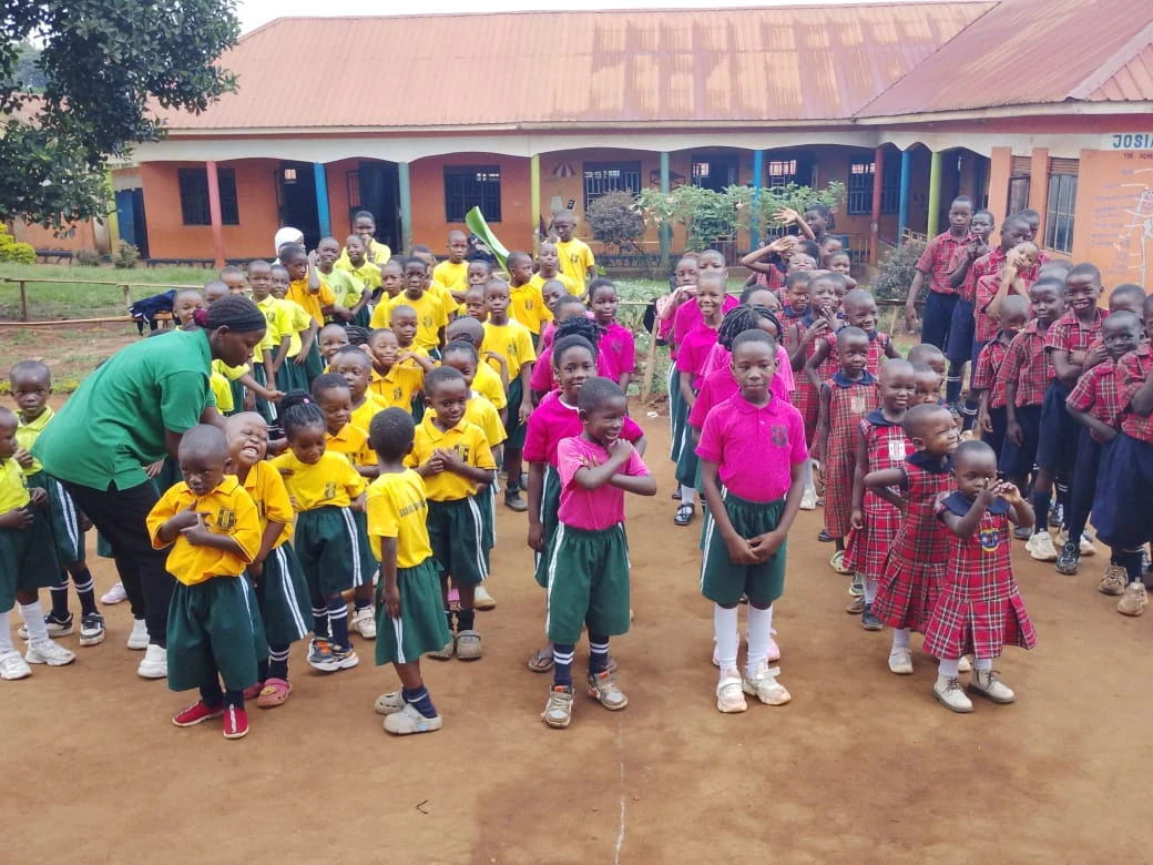 Children gathered outside Josianah Junior School in their colourful school uniforms