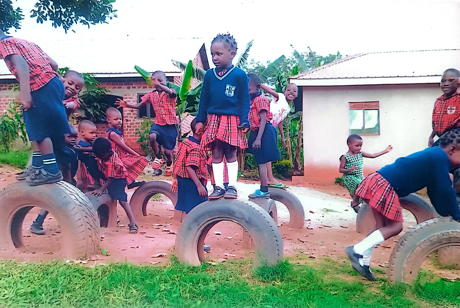 Pupils playing together on playground equipment at Josiana