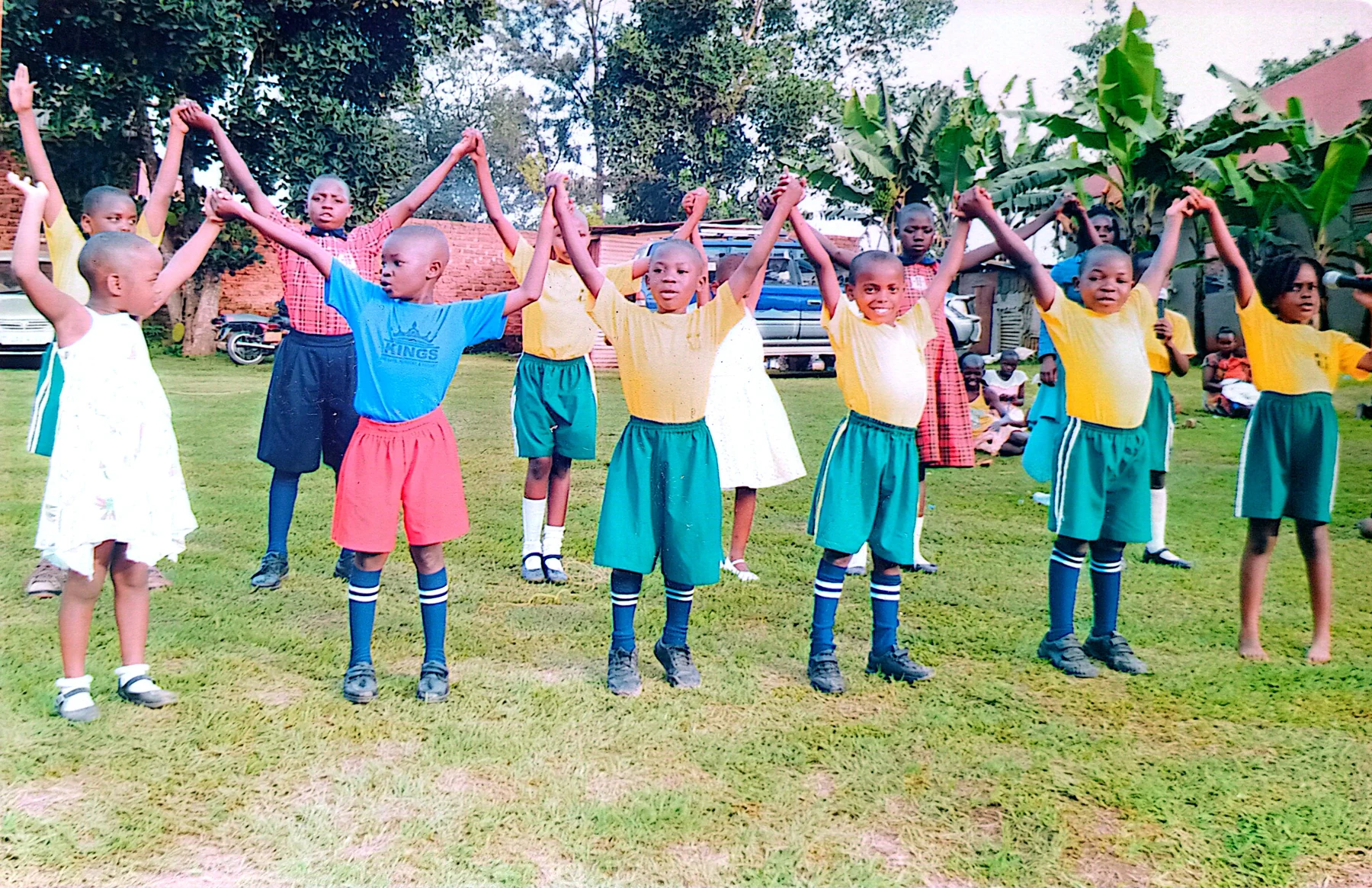Pupils standing together with staff in the school grounds