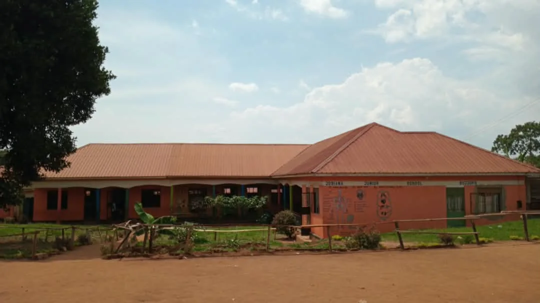 Josiana’s school buildings and grounds beneath a cloudy sky