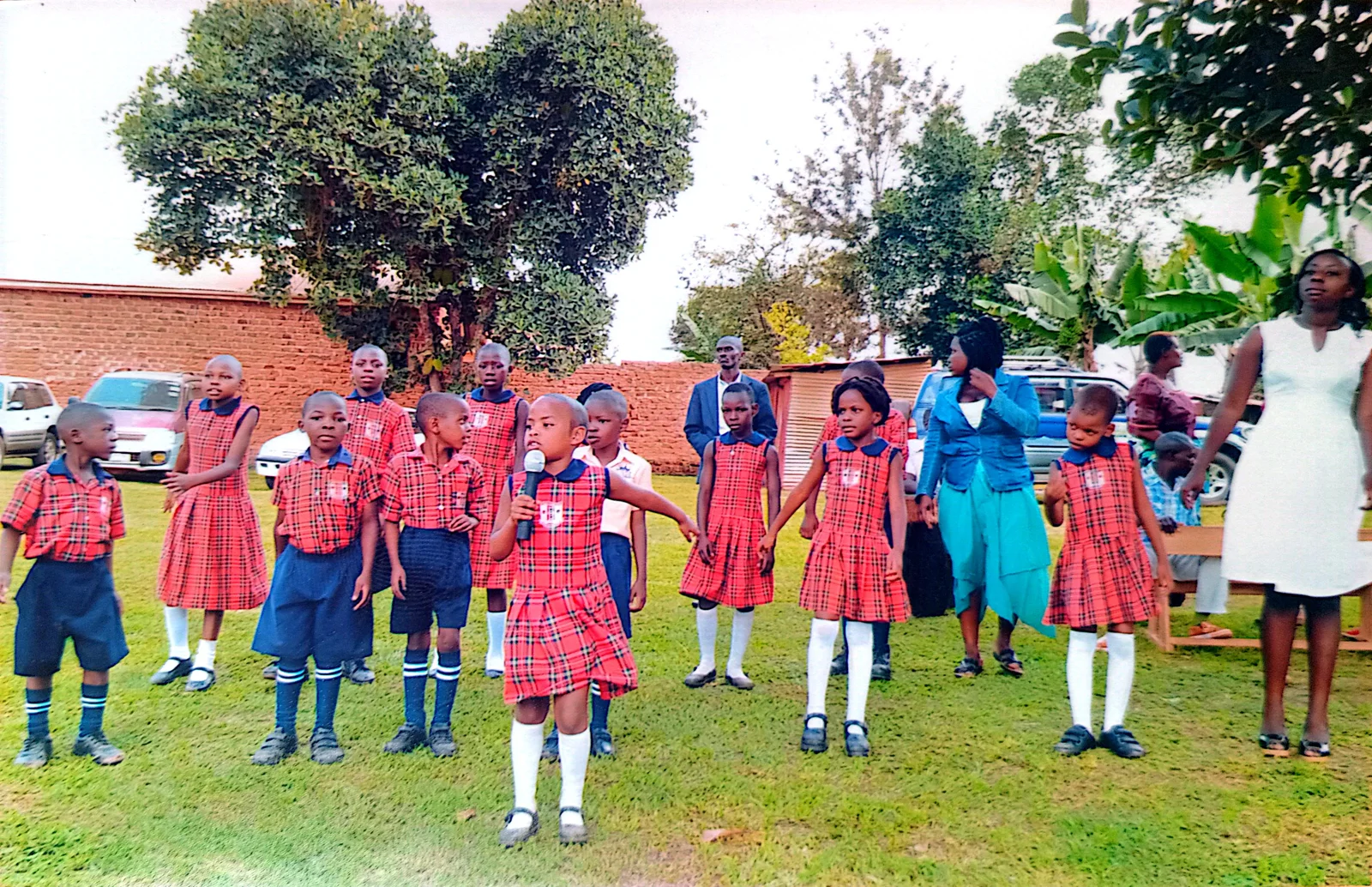Primary pupils standing together in the school grounds